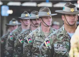  ?? Former Regimental Sergeant Major of 1RAR, 205th Corps Advisory Team, Warrant Officer Class One John Stonebridg­e during an end of mission ceremony. ??