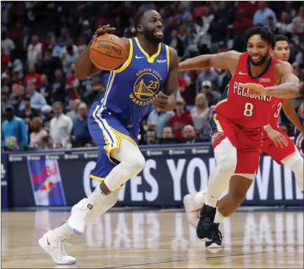  ?? GERALD HERBERT — THE ASSOCIATED PRESS ?? Warriors forward Draymond Green, who had a big night with a triple-double, drives to the basket against New Orleans center Jahlil Okafor.