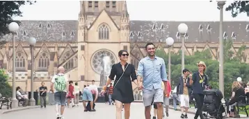 ??  ?? Tourists walk through Sydney’s Hyde Park, as St Mary’s Cathedral is seen in the background. China expects positive moves to signing up Australia for its New Silk Road initiative when Premier Li Keqiang visits this week, but two sources familiar with...