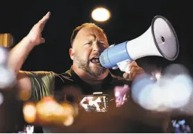  ?? Matt York / Associated Press 2020 ?? Infowars host Alex Jones rallies supporters of former President Donald Trump outside the Maricopa County Recorder’s Office in Phoenix on Nov. 5.