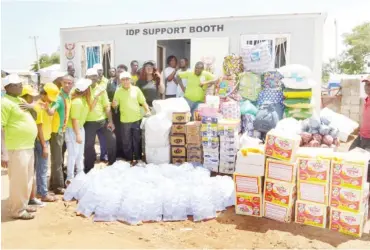  ?? Pic Onyekachuk­wu Obi ?? Institute of Peace and Conflict Resolution’s Director, Internal Conflict Prevention and Resolution, Peter Okpara (centre), donates relief materials on behalf of the institute to Internally Displaced Persons (IDPs) at the IDPs Camp in Durumi, Area 1,...