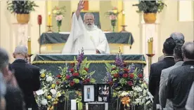  ?? CLIFFORD SKARSTEDT EXAMINER ?? Father Bill Moloney does the final blessing and dismissal during a funeral service for Gary 'Diller' Dalliday on Saturday at Sacred Heart Church.