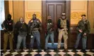  ?? Photograph: Seth Herald/Reuters ?? A militia group stands in front of the governor’s office at the state capitol in Lansing, Michigan, on 30 April.