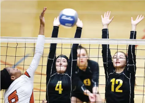  ?? PHOTOS: NICK BRANCACCIO ?? General Amherst Bulldogs Lexi Dodds, left, and Allison Dufour attempt to block a smash by Biamba Kabengele of Burlington’s Corpus Christi during OFSAA girls volleyball action at St. Clair College SportsPlex on Monday. The Bulldogs fell 2-0 to the Longhorns.