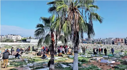  ?? AFP ?? People bury their dead who died in Israeli bombardmen­t in Rafah on the southern Gaza Strip on Friday.