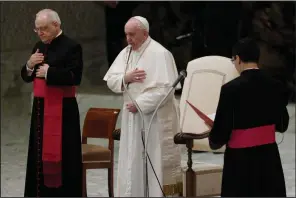  ?? (AP/Gregorio Borgia) ?? Pope Francis makes the sign of the cross Wednesday during his weekly general audience in the Paul VI Audience Hall at the Vatican.