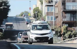  ?? JIM WILSON NYT ?? General Motors demonstrat­ed its new selfdrivin­g vehicle in San Francisco in 2017. Rideshare and car companies are all developing autonomous cars.