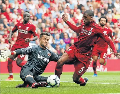  ?? Picture: CARL RECINE/ ACTION IMAGES VIA REUTERS ?? PUTTING THE FOOT IN: Liverpool's Georginio Wijnaldum, seen in action with West Ham's Lukasz Fabianski, has remained unfazed by competitio­n at the Reds this season.