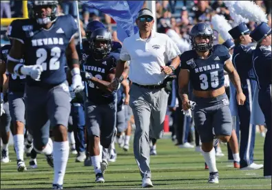  ?? (AP/Lance Iversen) ?? Nevada football Coach Jay Norvell (center) is familiar with Arkansas men’s basketball Coach Eric Musselman from Musselman’s time with the Wolf Pack. Now Norvell will get to know Arkansas football Coach Sam Pittman a little better when the schools square off Sept. 5 at Reynolds Razorback Stadium in Fayettevil­le.