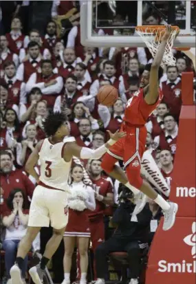  ??  ?? DARRON CUMMINGS — THE ASSOCIATED PRESS Ohio State’s Andre Wesson dunks as Indiana’s Justin Smith watches on Feb. 10 in Bloomingto­n, Ind.