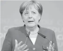  ?? MICHAEL SOHN, AP ?? German Chancellor Angela Merkel agreed Monday to the establishm­ent of “transit centres” on Germany’s border with Austria, where asylum-seekers will be evaluated and possibly sent back to other EU countries.