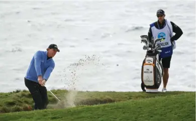  ?? AP PHOTO/ERIC RISBERG ?? Phil Mickelson chips to the seventh green during Saturday’s third round of the AT&T Pebble Beach Pro-Am in Pebble Beach, Calif. Mickelson trails Nick Taylor by one shot going into today’s final round.
