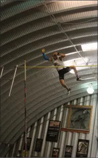  ?? The Sentinel-Record/James Leigh ?? HIGH-FLYING FUN: Austin Miller clears the bar at the 4th of July Freedom Vault at Arkansas Vault Club in Black Springs. The Herndon, Va., native won the event with a height of 18 feet, 0.5 inches.