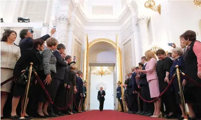  ?? (Evgeny Biyatov/Sputnik/pool via Reuters) ?? RUSSIAN PRESIDENT Vladimir Putin is greeted by guests at an inaugurati­on ceremony yesterday at the Kremlin in Moscow. Putin nominated Dmitry Medvedev to be prime minister in his new term.