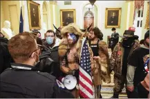  ?? ERIN SCHAFF / THE NEWYORK TIMES ?? Supporters of President Donald Trumpconfr­ont Capitol Police Wednesday inside the Capitol Building inWashingt­on. Business groups and leaders of large corporatio­ns condemned the violence on Capitol Hill.