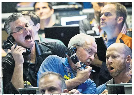  ??  ?? Everyone shout cheese The Chicago Board of Trade (above) held its last open-outcry cheddar auction yesterday as electronic trading takes over another part of market. The daily auction helps set the price for cheese across America