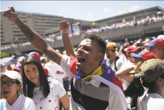  ?? Cristian Hernandez / AFP / Getty Images ?? Supporters of Venezuelan opposition leader Juan Guaido take part in an anti-government demonstrat­ion in Caracas. Guaido has offered amnesty to soldiers who join the opposition’s fight.