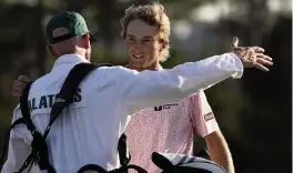  ?? DAVID J. PHILLIP AP ?? Will Zalatoris hugs his caddie, Ryan Goble, on the 18th hole after shooting a 2-under-par 70 to finish second by one shot in his first appearance in the Masters.