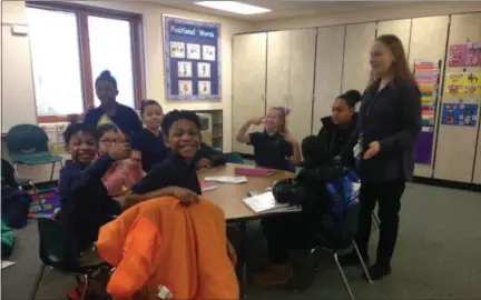  ?? JORDANA JOY — THE MORNING JOURNAL ?? Student council leader Megan Gierlach, right, announces during a Student Council meeting on Jan. 9 that Garfield Elementary School, 200 W. 31st St. in Lorain, has won the Salvation Army canned food drive.