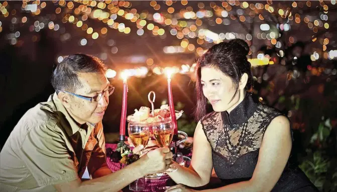  ??  ?? The writer (right) and her husband Adrian Yeong at their special hiking Valentine dinner at a hill in Alam Damai, Cheras, KL. — Photos: ADRIAN YEONG