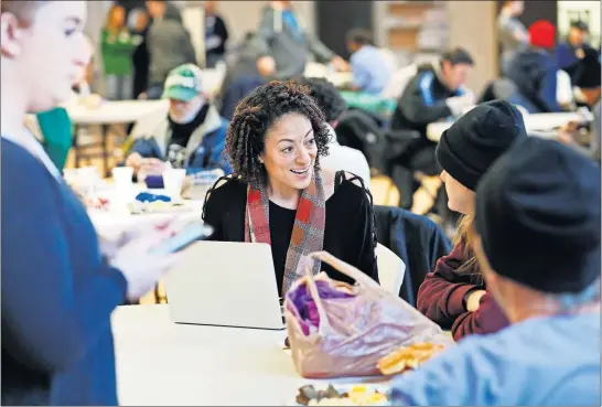  ?? [ADAM CAIRNS/DISPATCH] ?? Volunteer Gina Wilt surveys Jane Gessells while breakfast was being served at the Columbus Dream Center during the Community Shelter Board’s annual homeless count on Jan. 29. Approximat­ely 130 volunteers fanned out across the city to survey people for a oneday account of the homeless population.