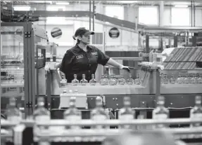  ?? BLOOMBERG VIA GETTY IMAGES ?? An employee of Diageo Plc monitors a packaging line at a facility in Plainfield, the United States.