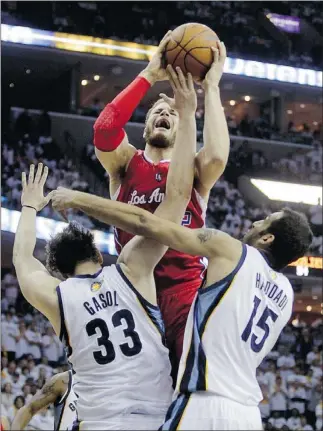  ??  ?? Los Angeles Clippers forward Blake Griffin (top) shoots over Memphis Grizzlies centres Marc Gasol and Hamed Haddadi during Game 7 on Sunday.