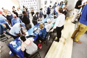  ?? Arkansas Democrat-Gazette/Staci Vandagriff ?? ■ Guests check in Saturday before the start of the Democratic Party of Arkansas’s biennial State Convention in the Ida Waldran Auditorium on the University of Central Arkansas campus in Conway.