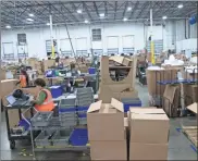  ?? / The Dallas Morning News-Daniel Carde ?? The end of November marks the beginning of busy season for people who work in returns management, so the Garland warehouse where Liquidatio­n.com sorts, packages and auctions off returned goods will kick into high gear through the new year.