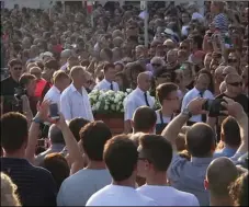  ?? AP PHOTO ?? In this image taken from video, people gather as the coffin carrying Oliver Dragojevic is taken through Split, on Tuesday. Tens of thousands of people bid an emotional farewell on Tuesday to Oliver Dragojevic, commemorat­ing one of the most popular pop...