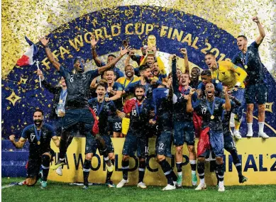  ?? MATTHIAS HANGST / GETTY IMAGES ?? Captain Hugo Lloris of France lifts the World Cup trophy to celebrate with his teammates after the 4-2 victory over Croatia in the championsh­ip game at Luzhniki Stadium on Sunday in Moscow.