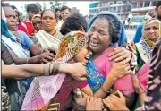  ?? AP/AJIT SOLANKI ?? Flood survivors have an emotional reunion Wednesday at a camp for the displaced in Gujarat, India.