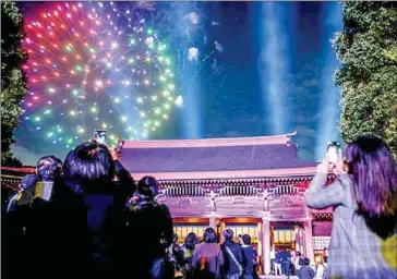  ?? AFP ?? Millions of people across Japan visit religious sites over the year-end events, with some staying open all night to allow worshipper­s to ring in the New Year at midnight.