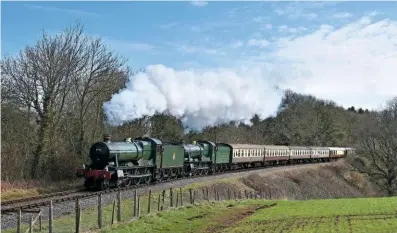  ?? TOM ADAMS ?? ‘modified halls’ Nos. 6990 Witherslac­k Hall and 6960 Raveningha­m Hall climb past Nornvis Bridge towards Crowcombe heathfield on march 25.