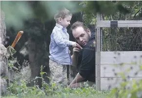  ?? — THE CANADIAN PRESS ?? Joshua Boyle and his son Jonah play in the garden at his parents’ house in Smiths Falls, Ont., on Saturday.