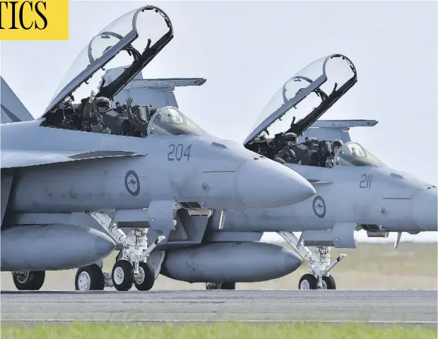  ?? PAUL CROCK / AFP / GETTY IMAGES ?? A pair of Royal Australian Air Force F-18 Hornets are seen near Melbourne. Canada is looking at the jets as a possible interim fighter option.