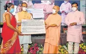  ?? SOURCED ?? CM Yogi Adityanath with others distributi­ng joining letters to assistant teachers under the Mission Rozgaar scheme at a function in Lucknow on Friday.