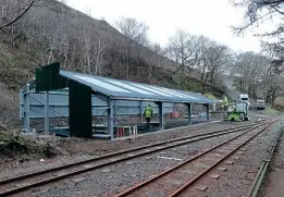  ?? KEITH THEOBOLD ?? Constructi­on of a new carriage shed during 2012, located five miles up from Tywyn at the site of the former Quarry Siding. It is named The Guest House, after Phil Guest, a long-serving Talyllyn volunteer, and was formally opened on May 5, 2012, by longtime supporters of the railway, Timothy West and Prunella Scales.