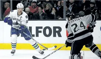  ?? THE ASSOCIATED PRESS FILES ?? Vancouver Canucks centre Henrik Sedin, left, passes the puck against Los Angeles Kings defenseman Derek Forbort during a game on March 4 in Los Angeles.