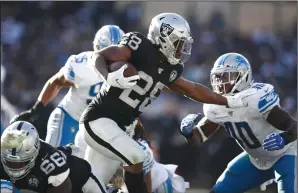  ?? EZRA SHAW/GETTY IMAGES/TNS ?? Josh Jacobs (28) of the Oakland Raiders runs with the ball against the Detroit Lions on Sunday in Oakland.