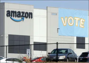  ?? (AP/Jay Reeves, File) ?? A banner encouragin­g workers to vote in union balloting is shown at an Amazon warehouse in Bessemer, Ala., in March. Union organizers say strict productivi­ty goals and high-tech employee monitoring were major factors in driving Amazon employees to seek representa­tion.