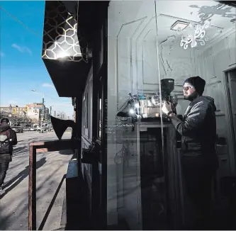  ?? NATHAN DENETTE
THE CANADIAN PRESS ?? Joshua Campos, owner of The Coffee Lab, poses for a photograph while making a cup of coffee in his 18-square-foot small retail space located on Spadina Ave. in Toronto.