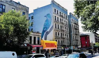  ?? ?? A blue pinyon jay painted by Vermont artist Mary Lacy perches at 3668 Broadway in Manhattan.
