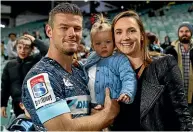  ??  ?? Rob Horne with his family after his final game for the Waratahs in 2017.