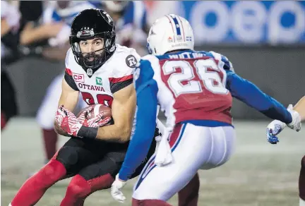  ?? PAUL CHIASSON/THE CANADIAN PRESS ?? Redblacks wide receiver Brad Sinopoli braces for impact as he’s tracked down by Montreal defensive back Tyree Hollins in the first quarter Thursday, en route to Ottawa’s 32-4 win over the Alouettes at Percival Molson Memorial Stadium in Montreal.