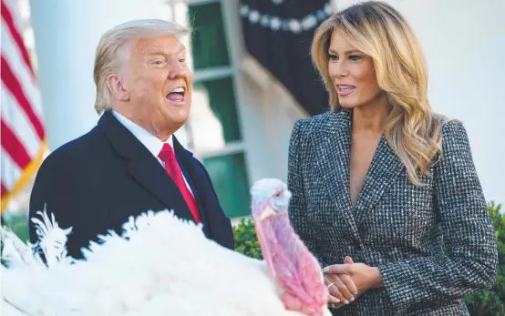  ??  ?? US President Donald Trump, with First Lady Melania, pardons Corn, the thanksgivi­ng turkey, at the White House.
Picture: MANDEL NGAN/AFP