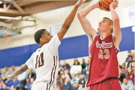  ?? STAFF PHOTO BY TIM BARBER ?? Van Buren County standout Caden Mills shoots over Tyner’s Solomon Bridgemon during the second half of their first-round game at the Best of Preps tournament Thursday at Chattanoog­a State. Van Buren survived a 75-69 thriller in overtime and will face...