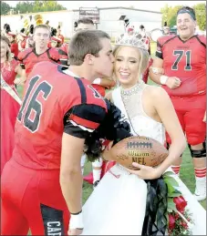  ?? MARK HUMPHREY ENTERPRISE-LEADER ?? Farmington 2017 Homecoming queen Madalynn Bradley receives a kiss on the cheek from Farmington football captain Caleb Williams, who had just crowned her.