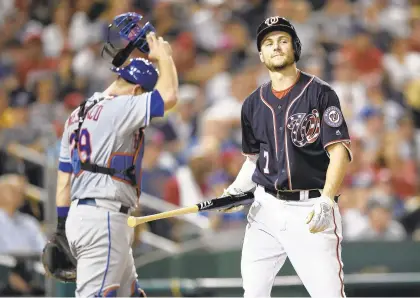  ?? NICK WASS/AP ?? The Washington Nationals’ Trea Turner reacts after striking out in Friday’s sixth inning against Devin Mesoraco, left, and the Mets, who won 4-2.