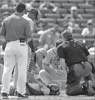  ?? ADAM HUNGER / REUTERS ?? Jason Heyward lies on the ground after being hit in the head by a pitch from New York Mets starter Jonathon Niese during the sixth inning of their National League game at CitiField in New York on Wednesday. The Mets won 4-2.